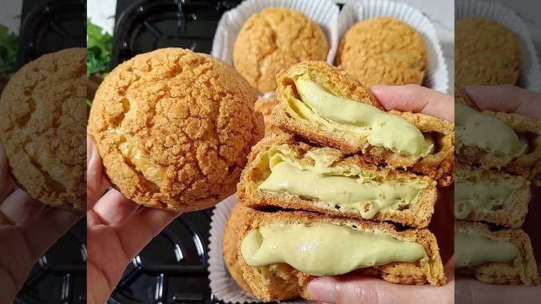 A pair of hands holding pistachio cream choux with three open buns
