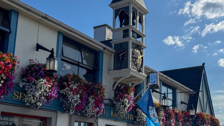 Front exterior of The Morgue with clock tower under blue sky