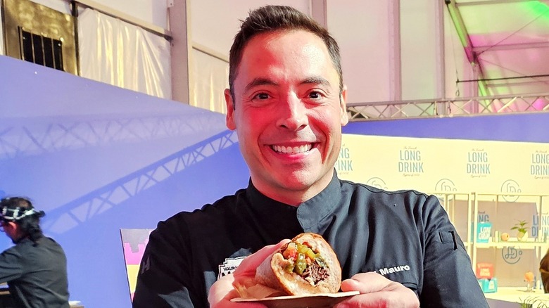 Jeff Mauro holding his Italian beef sandwich