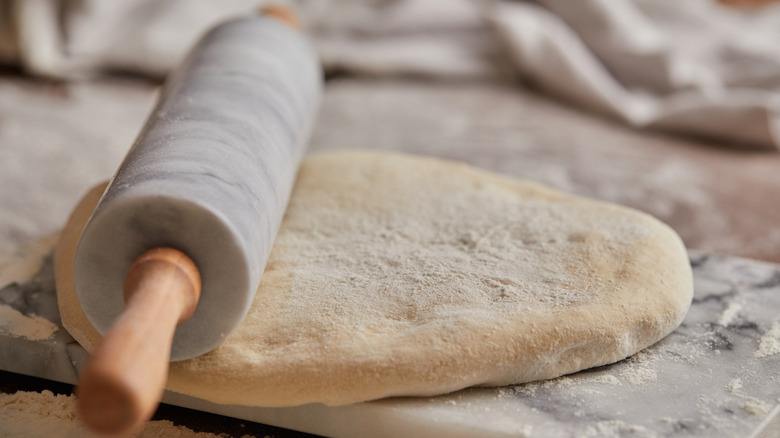 Marble pin on top of dough