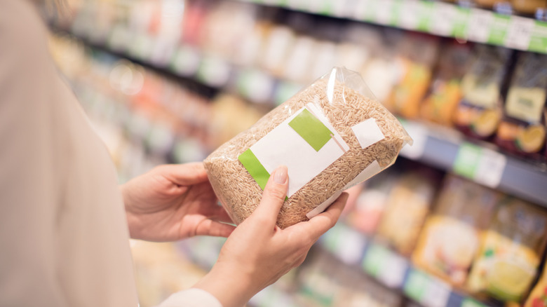 a bag of rice in the dry good aisle of a grocery store