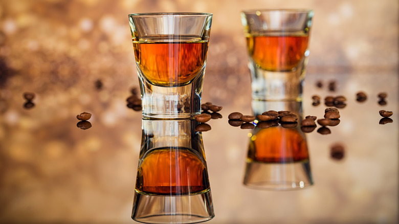 two shot glasses with bourbon 