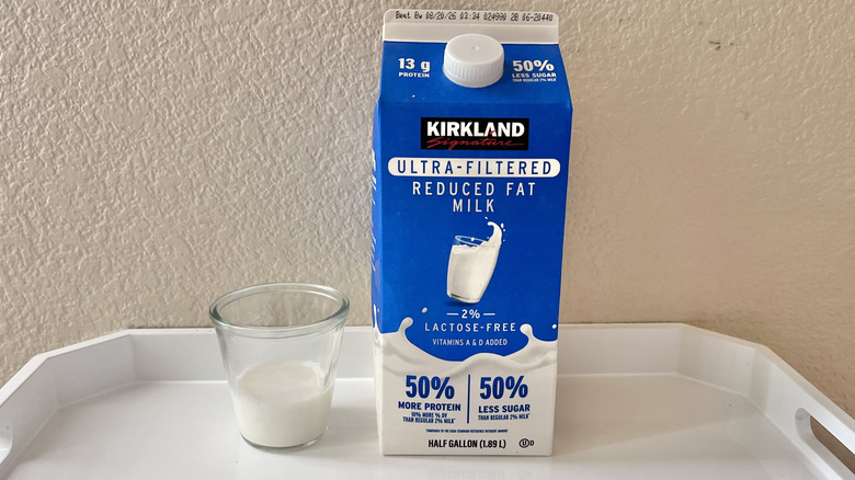 A carton of Kirkland Signature Ultra-Filtered 2% milk on a tray
