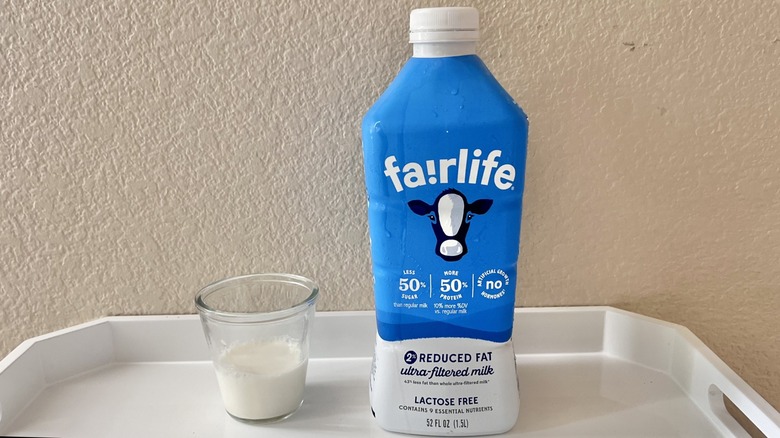 Fairlife carton with a glass of milk on a tray