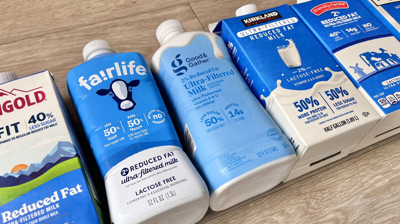 Various milks on a wooden counter top