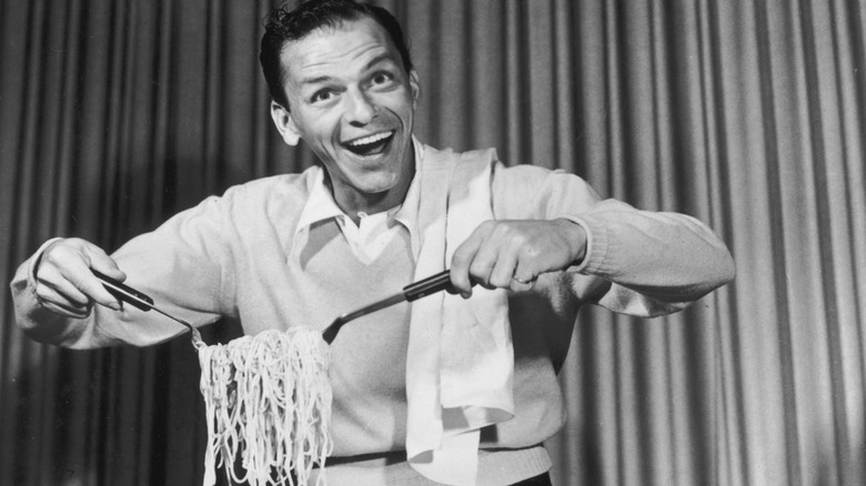 Sinatra plays with pile of spaghetti on stage