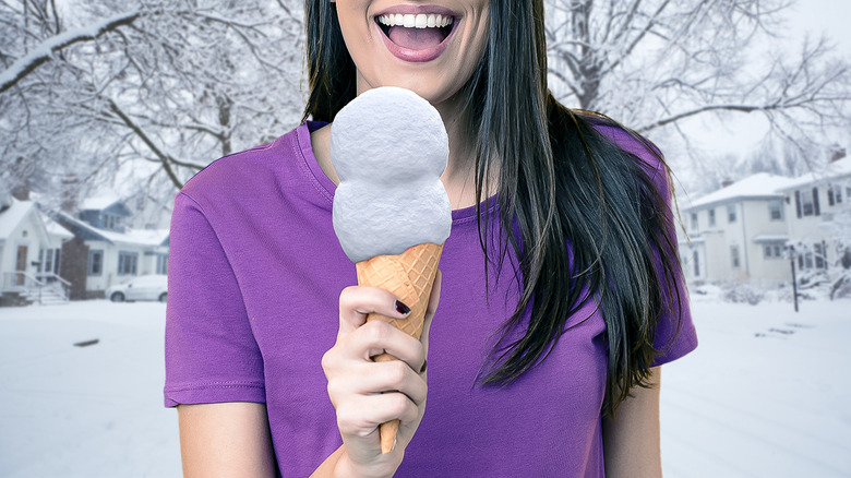 Woman with ice cream cone filled with snow