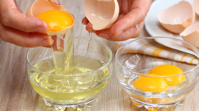 cracking egg whites into a bowl