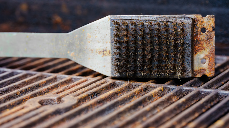 Wire brush cleaning off rusty grill grates
