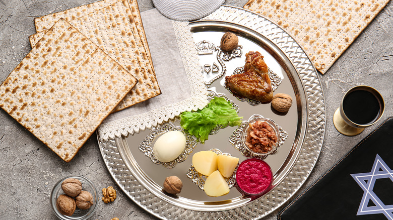 Top-down view of a silver Passover Seder plate with traditional food