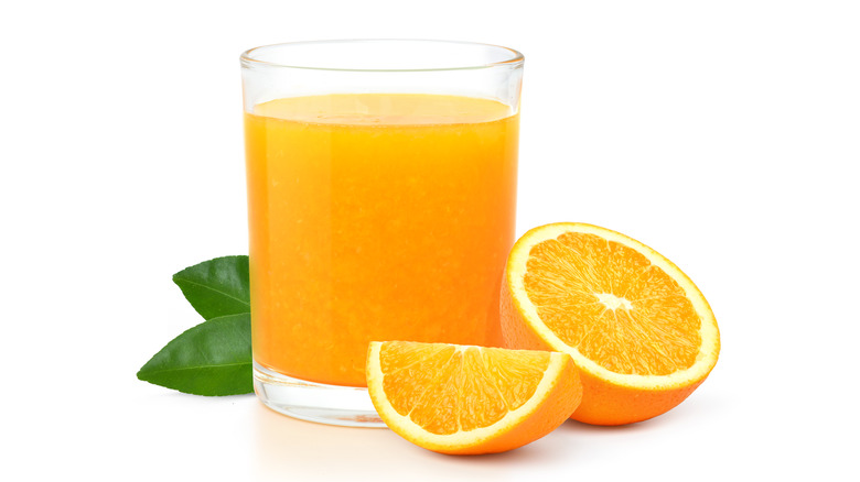 Glass of juice with oranges