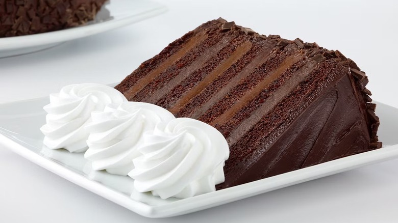 cheesecake factory's chocolate cake with whipped cream on plate