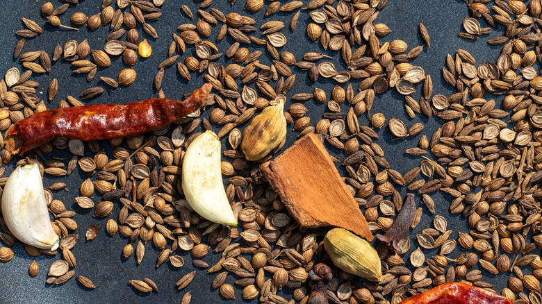 Tosted cumin seeds with cardamom, garlic, cinnamon, and red chili