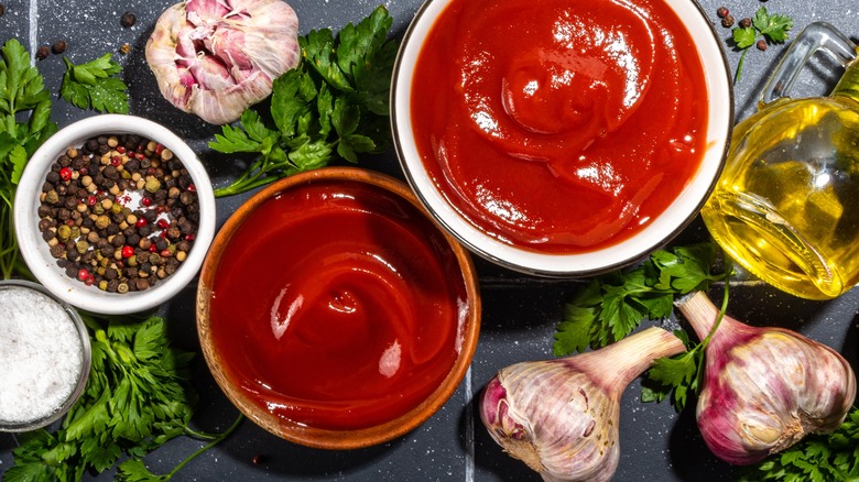 Two types of ketchup alongside seasonings