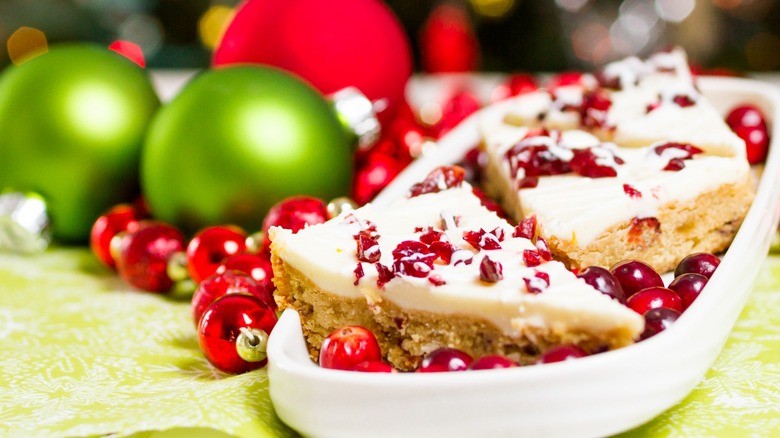 Cranberry Bliss Bars next to red and green holiday ornaments