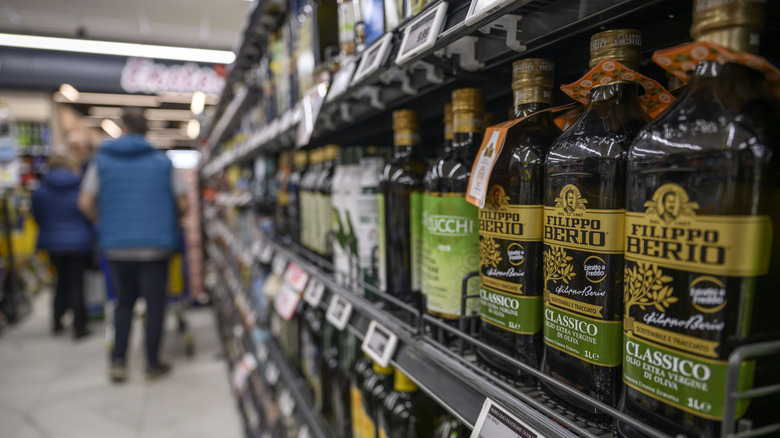 Close-up of olive oils in grocery store aisle