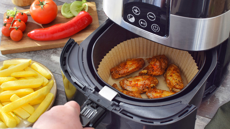 chicken wings in air fryer with parchment paper liner