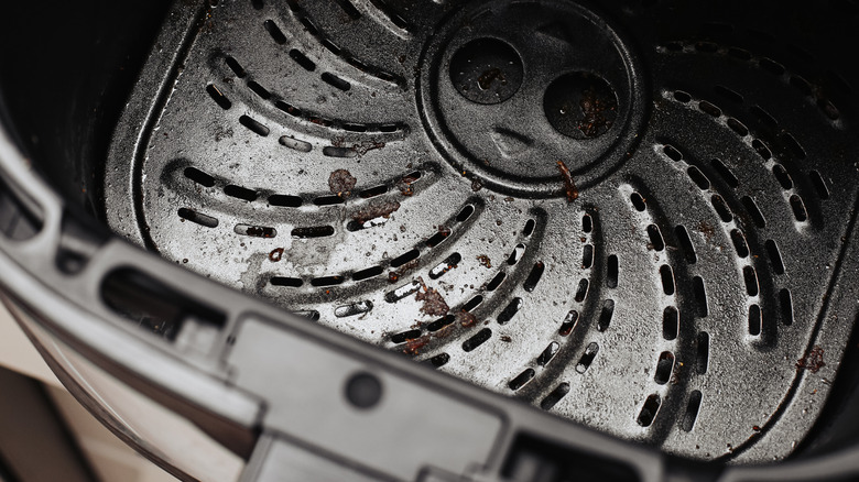 close up of the bottom of a dirty air frying basket