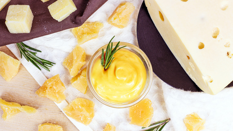 cheese sauce in bowl with rosemary