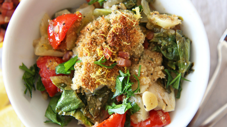 Bowl of Utica greens salad topped with cheesy breadcrumbs