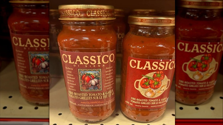 An old jar of Classico's Fire-Roasted Tomato & Garlic pasta sauce beside a newer, smaller one