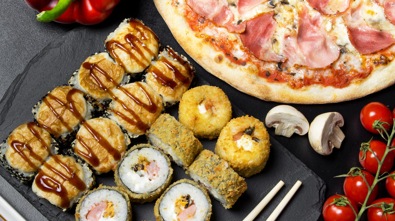 Pizza and sushi with vegetables