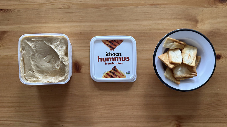Ithaca French Onion Hummus on wooden table with pita chips