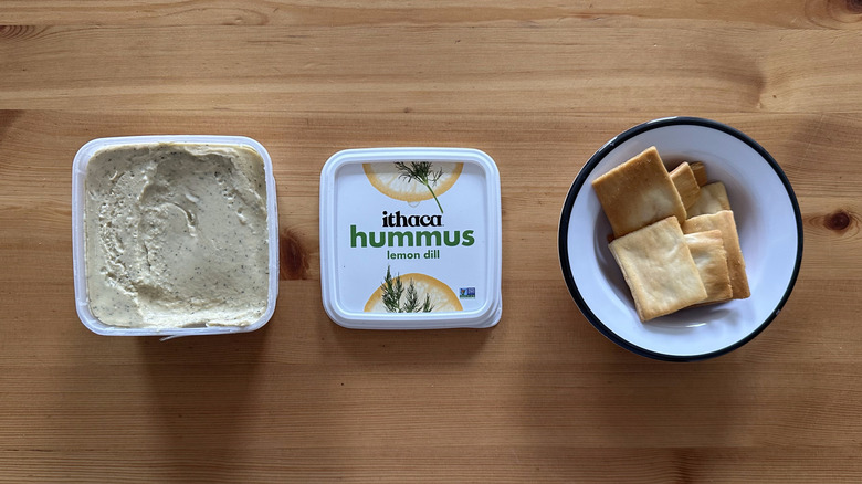 Ithaca Lemon Dill Hummus on wooden table with pita chips
