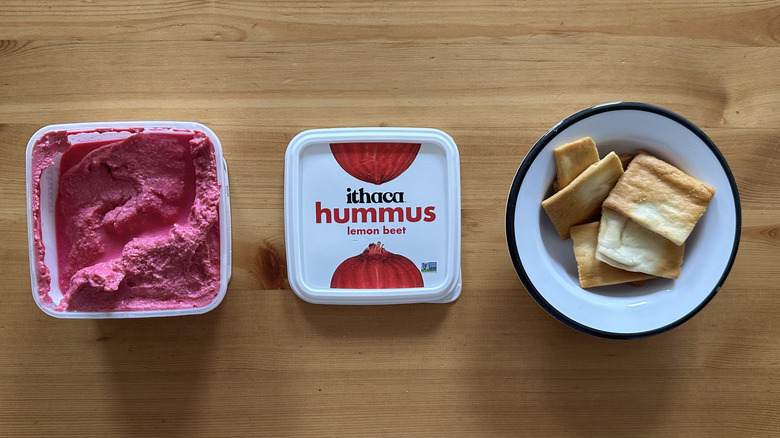 Ithaca Lemon Beet Hummus on wooden table with pita chips