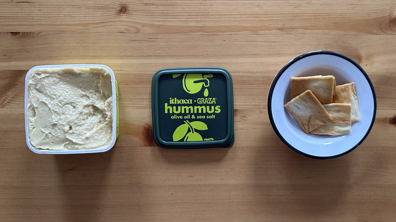 Ithaca x Graza Olive Oil and Sea Salt Hummus on wooden table with pita chips