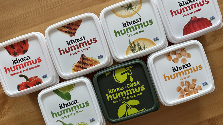 Ithaca hummus containers arranged on wooden table
