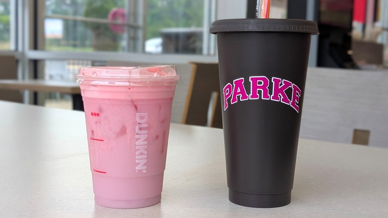 A Dunkin' Parke Daydream Refresher next to a black Parke tumbler