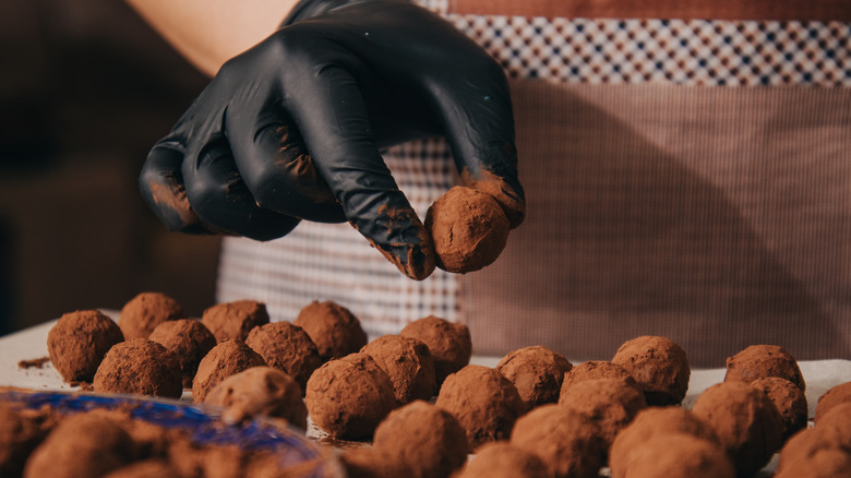 Baker making classic chocolate truffles 