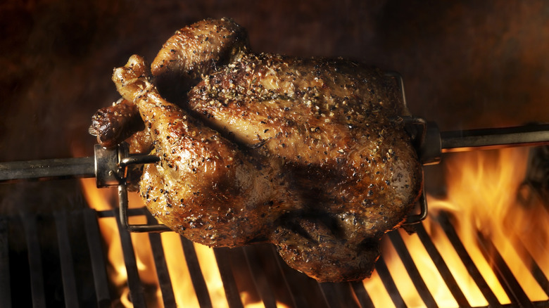 turkey being grilled on grates