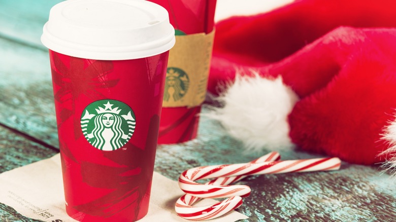 Starbucks Peppermint Mocha in red cup next to candy canes 