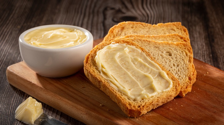 Spread butter on bread