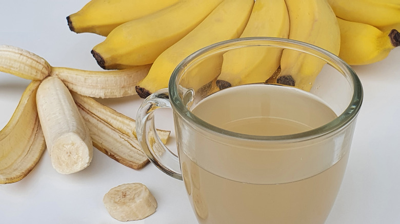 Cup of tea with bunches of bananas