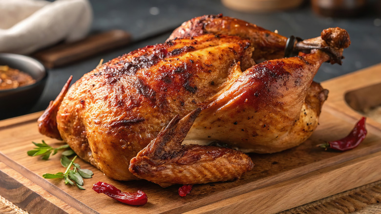 whole roasted chicken on cutting board