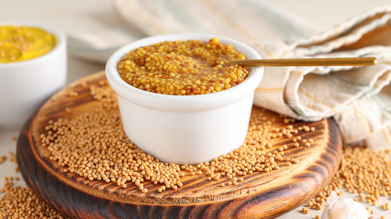 Bowl of Dijon mustard with seeds and garlic