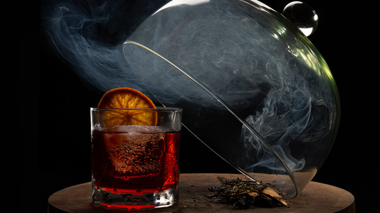 Smoked Negroni cocktail under glass