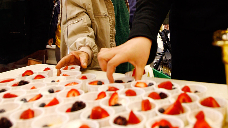 Customers taking free samples of berries