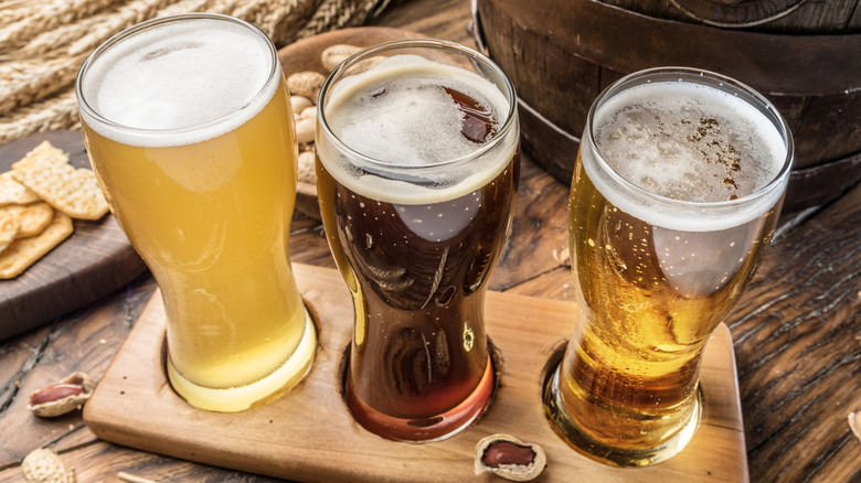 Flight of beer beside a cask
