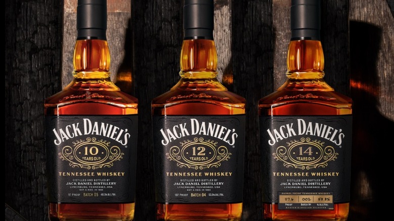 The three new Jack Daniel's Aged Whiskey bottles lined up against a black backdrop