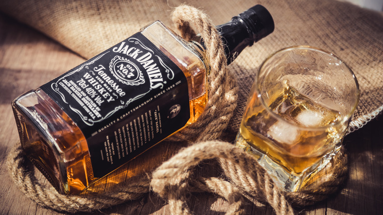 Bottle of whiskey and rope