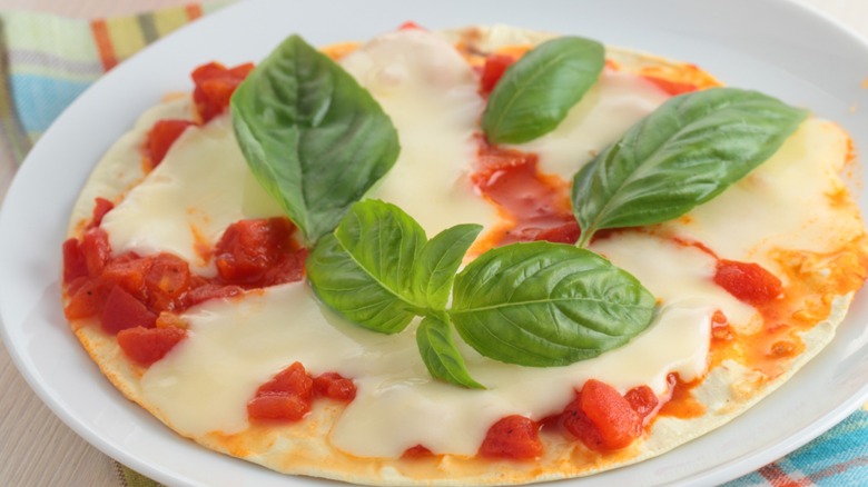 Tortilla pizza topped with basil