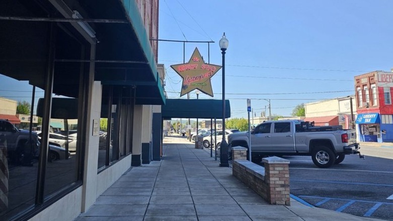 Sidewalk and building exterior of The Bright Star with sign