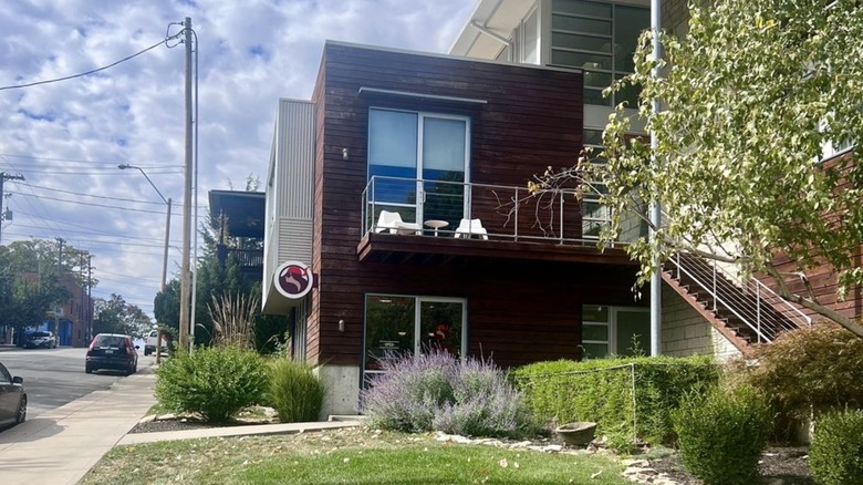 Two-story slat wood building on suburban street