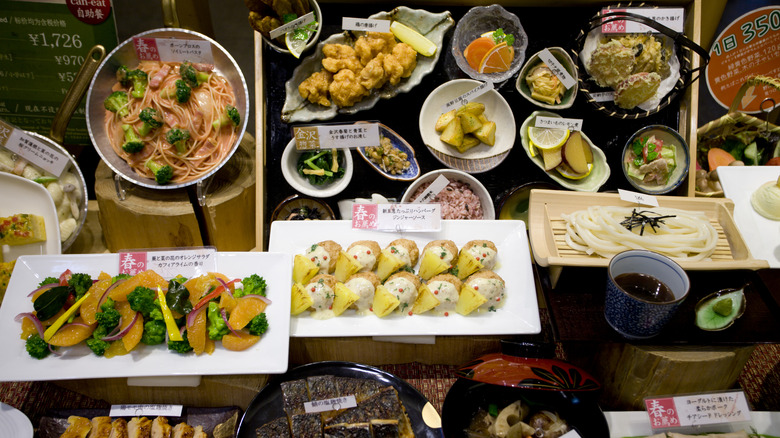 Plastic food displays outside a Japanese restaurant showing dumplings, ramen and various other dishes