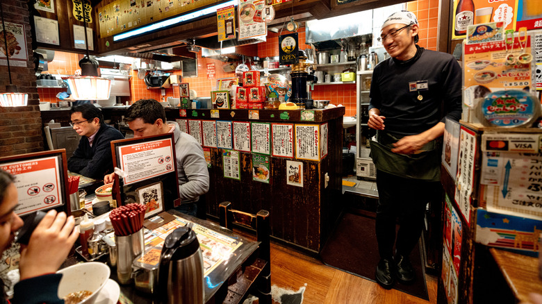 interior of a small ramen restaurant in Japan with customers