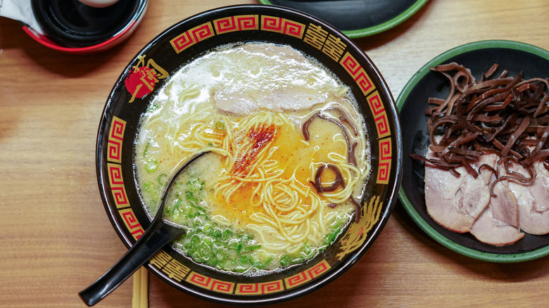 Bowl of ramen with extra toppings on the side